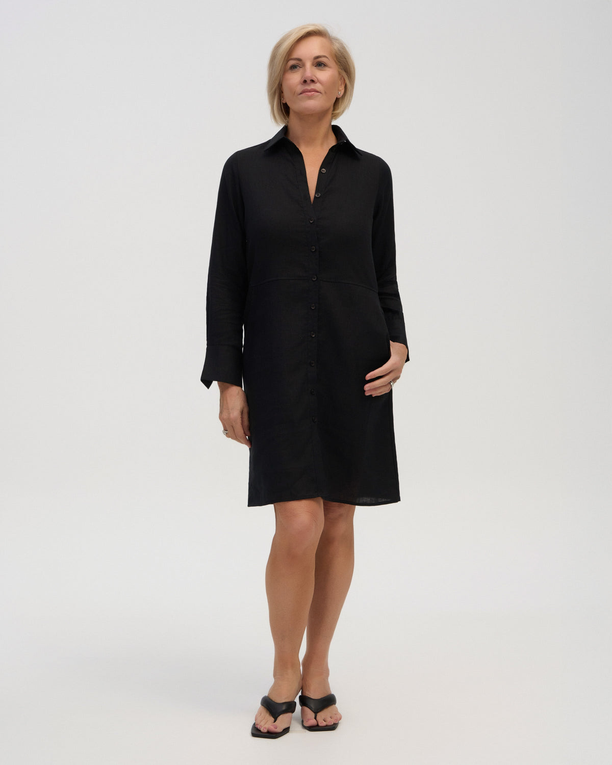 “Model wearing black linen shirt dress wide cuffs”