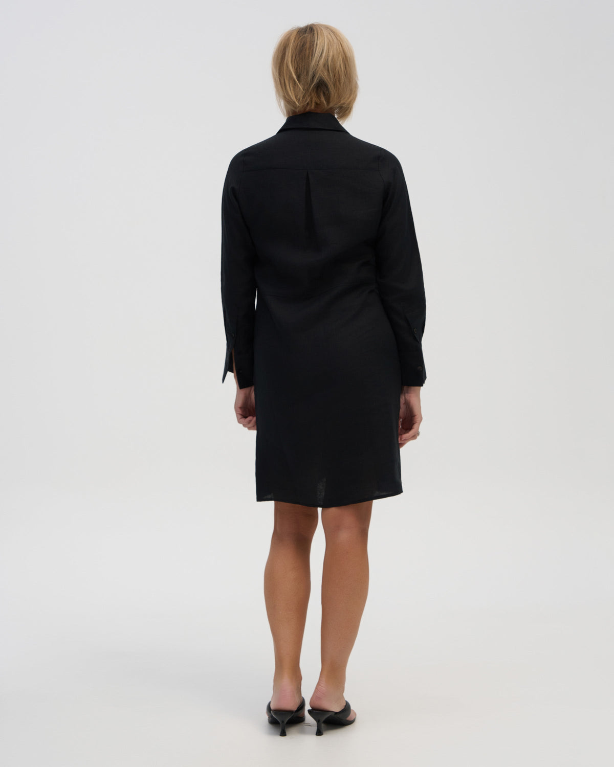 “Classic black linen dress with collar and cuffs”